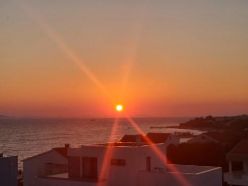 a sunset over the ocean with the sun setting at Apartman Dalmatino in Petrcane