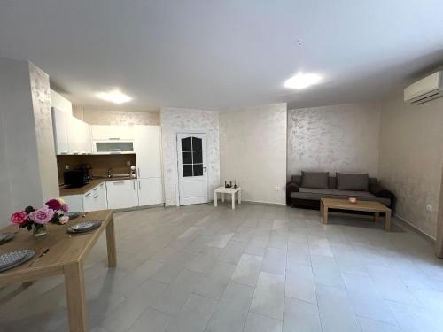 a living room with a couch and a table at Nikol Apart in Balchik