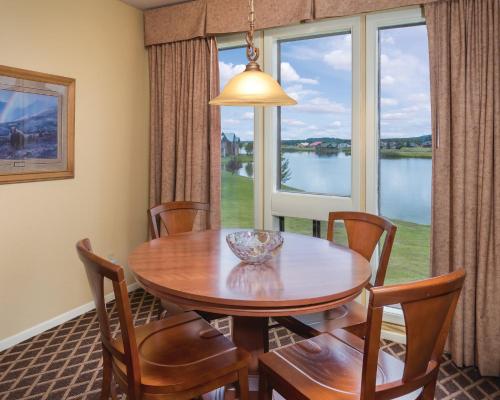 a dining room with a table and chairs and a large window at Wyndham Pagosa Springs 1BR Apartment with Resort Access in Pagosa Springs