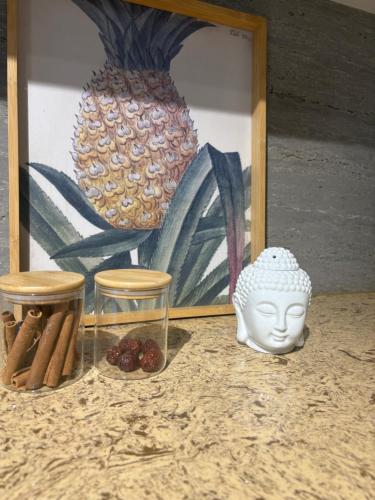 a picture of a vase and a statue in front of a painting at Red Yurt Hostel in ULN