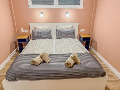 a bedroom with a bed with two slippers on it at Casa Monia in Antigua