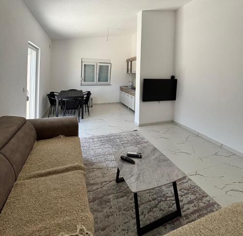a living room with a couch and a table at Apartmani Kula in Pečurice