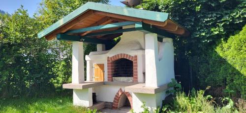a small brick oven with a blue roof at Ferienhaus Aich by Alpenidyll Apartments in Gössenberg