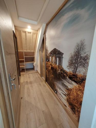 a hallway with a painting on the wall at Le Dreispitz, Gîte d'Exception en Alsace in Gresswiller