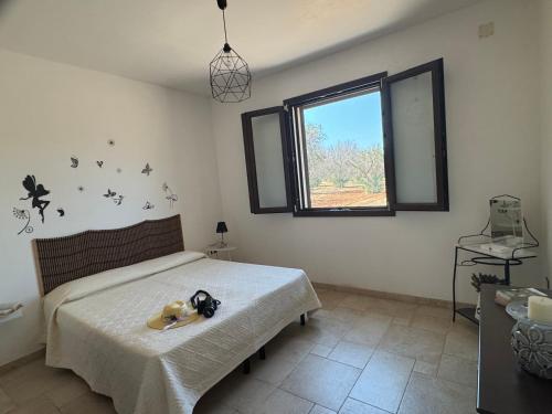 a bedroom with a bed with a toy duck on it at Villetta Aleanna in Serranova