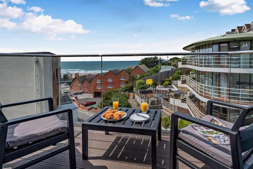 a balcony with a table with a bowl of food on it at 9 Middlecombe - Luxury Apartment at Byron Woolacombe, only 4 minute walk to Woolacombe Beach! in Woolacombe