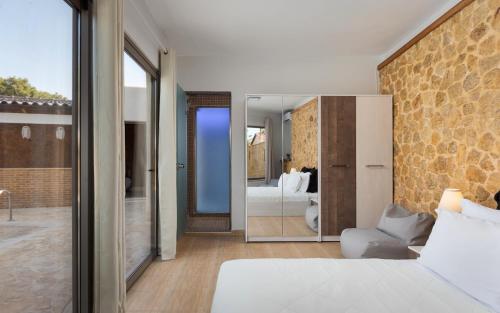 a bedroom with a bed and a view of a bedroom at Aeolia Villa Athenian Riviera in Anavissos