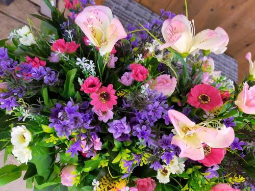 a bouquet of pink and purple flowers at Hopgarden Glamping and camping - Luxury furnished Bell tents & Shepherd huts plus camp field to pitch your own tents in Wadhurst