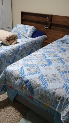 a bed with a quilt on it in a bedroom at Espaço da Sisi in Hortolândia