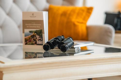 a pair of binoculars on a table next to a box at Grand Hotel Binz in Binz