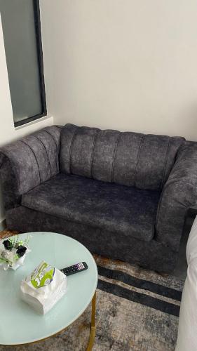 a couch in a living room with a table at Sophie's place in Nairobi