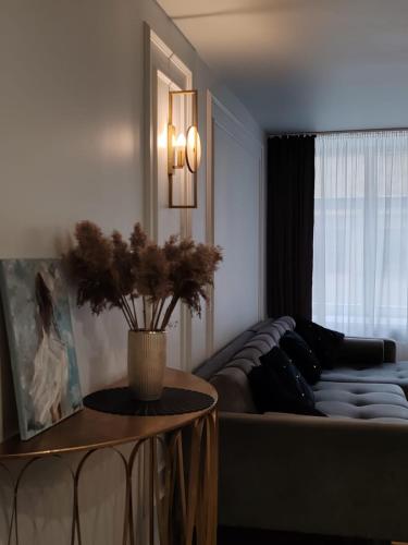 a living room with a couch and a table at Old Town Apartment in Rīga