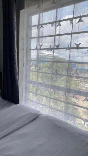 a bedroom with a window with a view of the ocean at Sophie's place in Nairobi