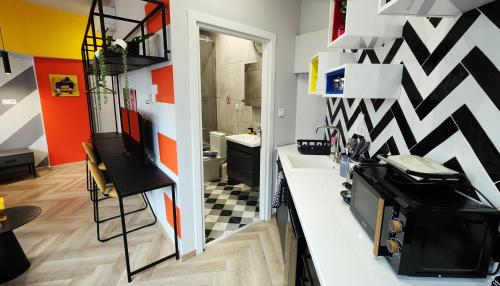 a kitchen with a black and white checkered wall at YalaRent Athens Central Suites Retreat in Athens