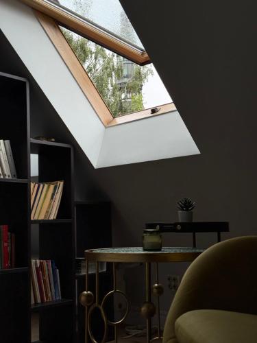 a skylight in a room with a table and a window at Old Town Apartment in Rīga