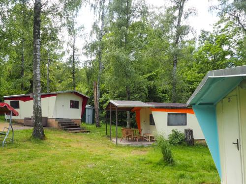 a group of cottages in the woods at TRABI- Bungalows am Naturteich in Machern