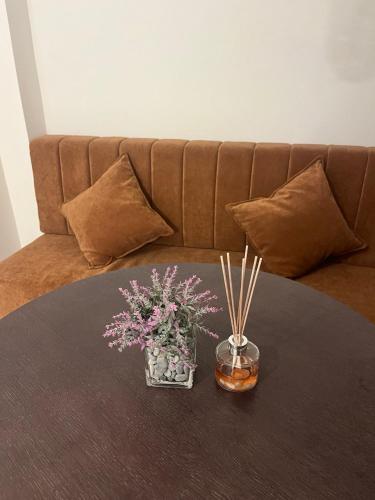 a table with flowers in a vase on a couch at Casa Del Sol Pietra Kotor in Kotor
