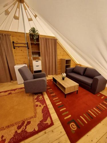 a living room with a couch and a table at Gyulai Camping en Resort in Gyula