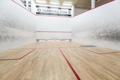 an empty gymnasium with a wooden floor in a room at Cube Apartamenty in Lublin
