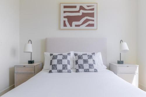 a white bedroom with a white bed and two lamps at Blueground Round Rock pool nr Old Settlers Park ATX-327 in Austin