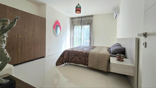 a bedroom with a bed and a window at Tabarja Hills apartment in ‘Ayn aş Şughayrah