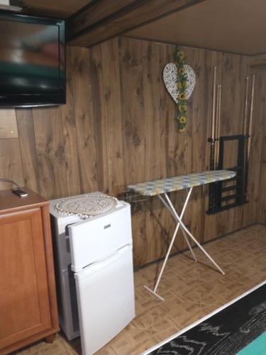 a kitchen with a table and a small refrigerator at Pokój w centrum in Ustroń