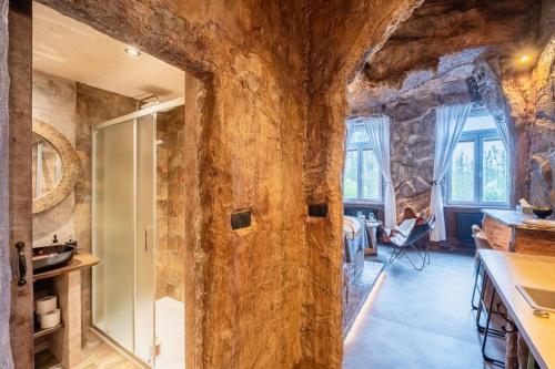 a large wooden door in a room with stone walls at Apartmány v Podzámčí v blízkosti zámku Blatná in Blatná