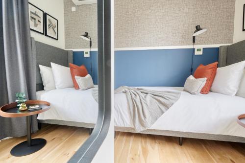 a hotel room with two beds and a table at The Chapter Hotels - Camden Town in London