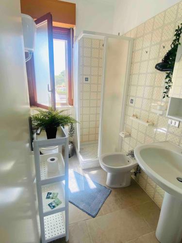 a bathroom with a toilet and a shower and a sink at Authentic Puglia Seaside Condo in Scalo dei Saraceni Manfredonia