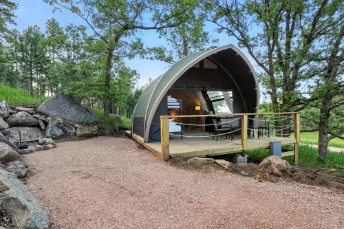 a dome house with a deck in a forest at Cloud Nine Tent #3 - The Oak Oasis in Hermosa