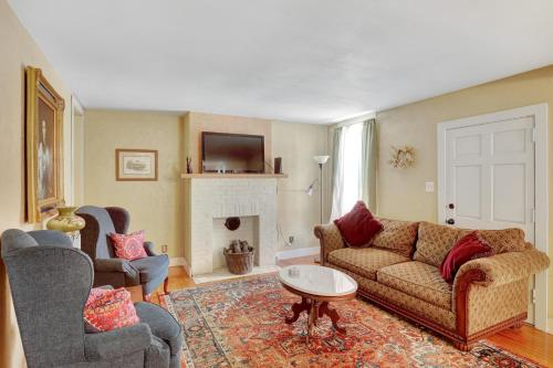 a living room with a couch and a fireplace at Historic Downtown Gettysburg Gem in Gettysburg