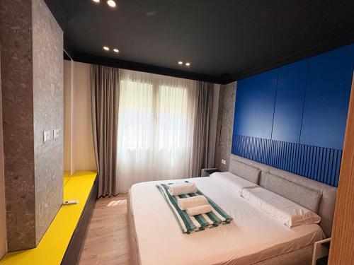 a bedroom with a large white bed with blue walls at Escape Luxury Apartment 2 Shengjin in Shëngjin