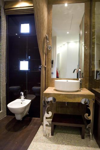 a bathroom with a sink and a tub and a toilet at Hotel Exclusive in Agrigento