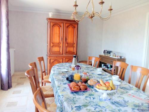 a dining room with a table with fruit on it at Chambres D'hôtes De Kerantum in Mahalon