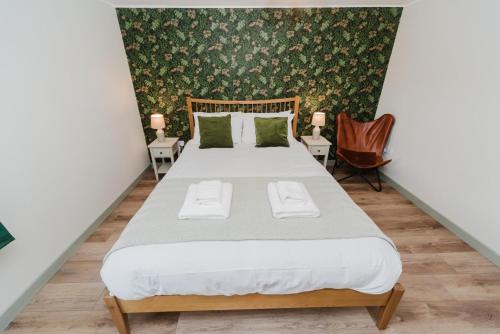 a bedroom with a bed with two towels on it at The Hebridean - Rooms & Apartments in Broadford