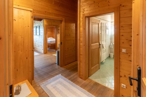 a hallway of a cabin with wooden walls and wooden floors at Madlhof in Himmelreich