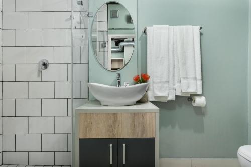 a bathroom with a sink and a mirror at 53 on Castle by Neighbourgood in Cape Town