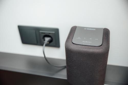 a cell phone is plugged into a wall outlet at Albert Studio in Art Nouveau building with AC Top location near old town in Rīga