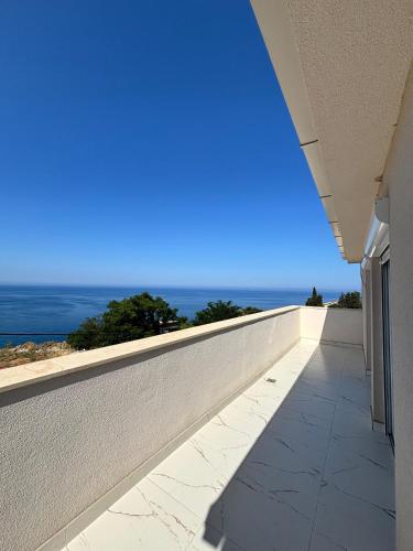 a balcony with a view of the ocean at Apartmani Kula in Pečurice