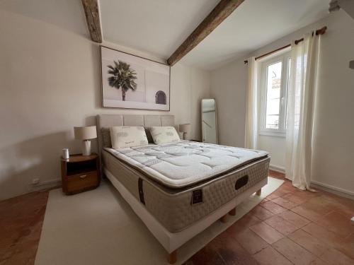 a bedroom with a large bed in a room with a window at La bâtisse de Coustouge in Coustouge
