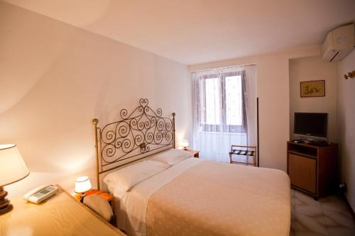 Postel nebo postele na pokoji v ubytování Hotel Moderno
