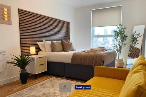 a bedroom with a large bed and a window at 3 Bedroom Apartment By Paul & Malin Properties Short Lets & Serviced Accommodation Stretford With Gym Access in Manchester