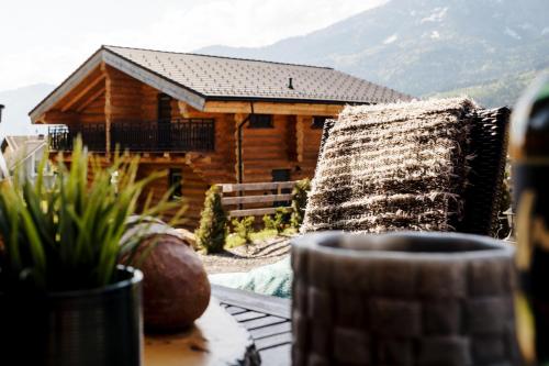 a log cabin with a view of the mountains at Clofers Leisure Lodges Jenig in Jenig