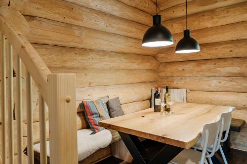 a wooden dining room with a table and a staircase at Clofers Leisure Lodges Jenig in Jenig
