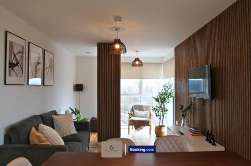 a living room with a couch and a table at 3 Bedroom Apartment By Paul & Malin Properties Short Lets & Serviced Accommodation Stretford With Gym Access in Manchester