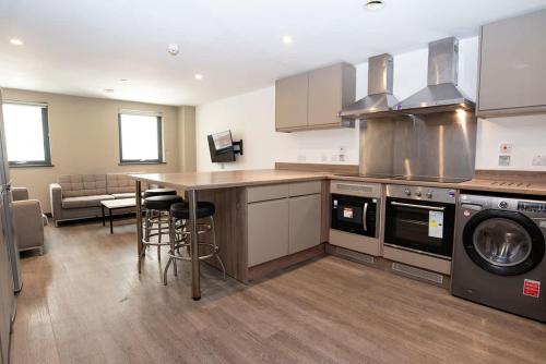 a kitchen with a counter and a table in it at Ensuite Single Room in Central Coventry in Coventry