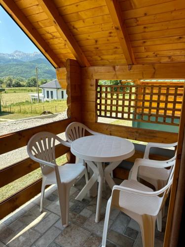 a table and chairs on the porch of a cabin at Gusinje View in Gusinje