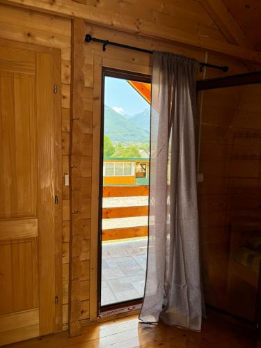 a window in a room with a view of a mountain at Gusinje View in Gusinje