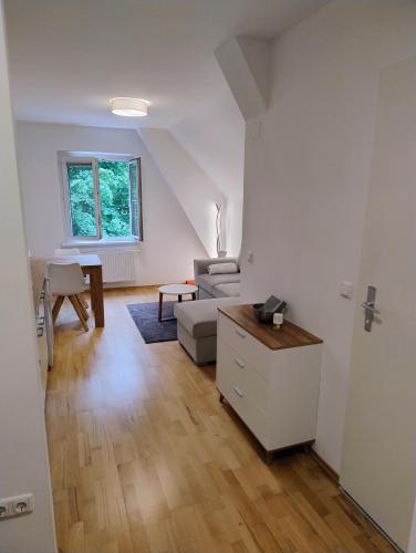 a living room with a couch and a table at CityLeaves Apartments TWO in Sankt Aegyd am Neuwalde