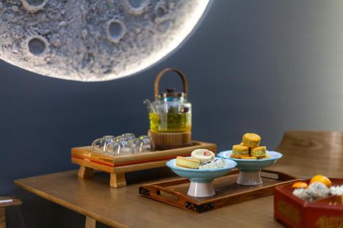 a table with two plates of food on it at Xingshengjiu Courtyard Hotel Pingyao in Pingyao